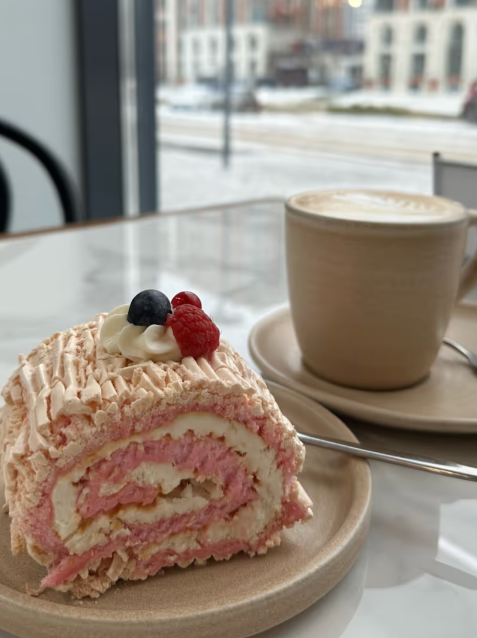 Meringue roll with raspberries and original coffee