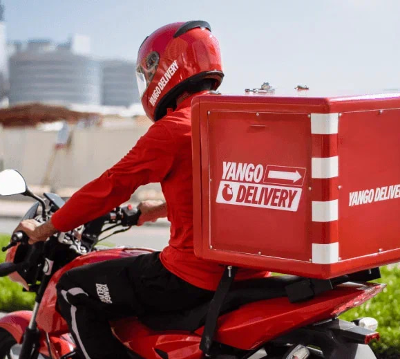 A delivery worker driving a bike