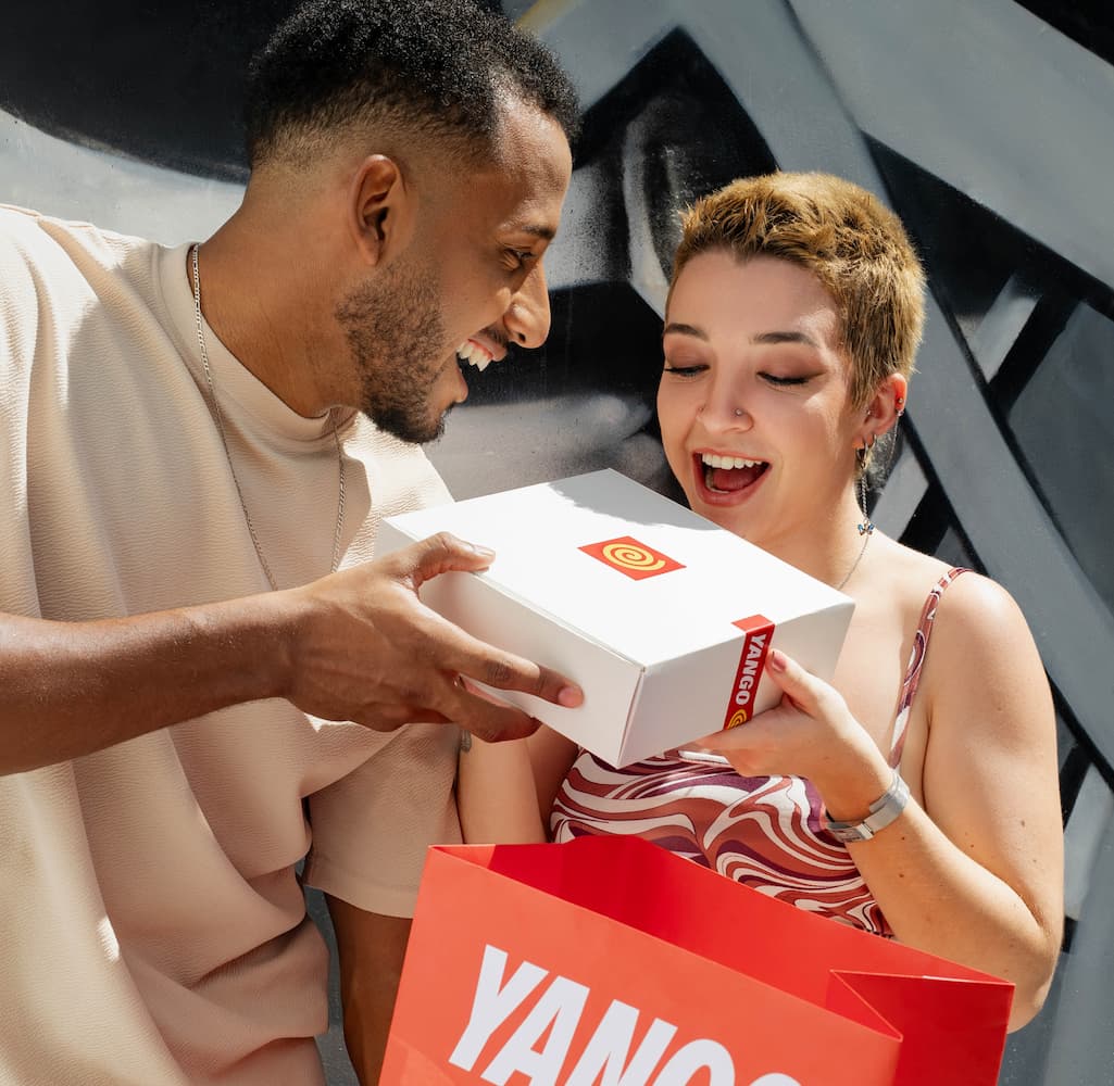 A man handing a Yango box to a woman