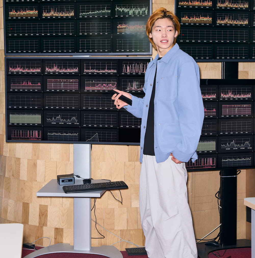 A man standing in front of graphs of data