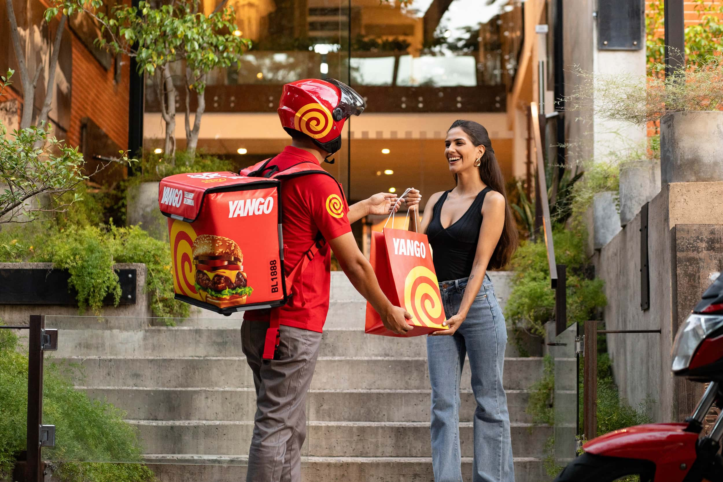 A man handing a bag to a woman